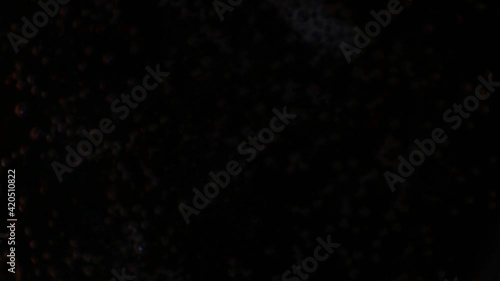 Close-up of black bubbles on a drink