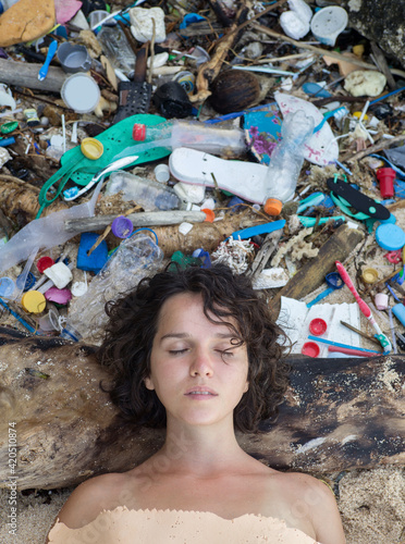 Woman portrait on plastic trash background photo