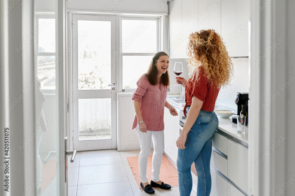 Friends laughing in a kitchen Friends laughing in a kitchen