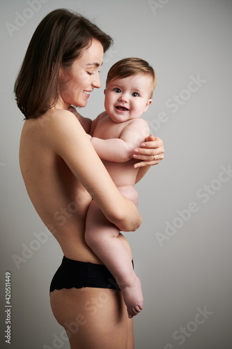 Naked mother with happy baby photo