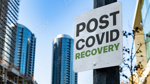 Post Covid Recovery Worn Sign in Downtown city setting
