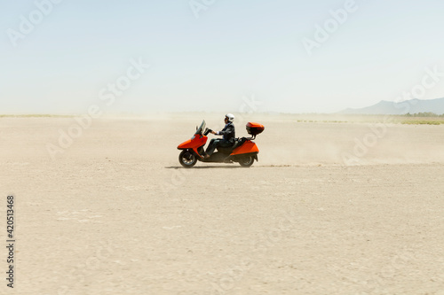 Man Driving a scooter in the desert