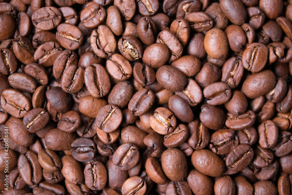 close up of Freshly roasted coffee beans background. top view close up of Freshly roasted coffee beans background. top view