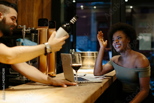 Restaurant staff sharing a drink at the end of their shift photo