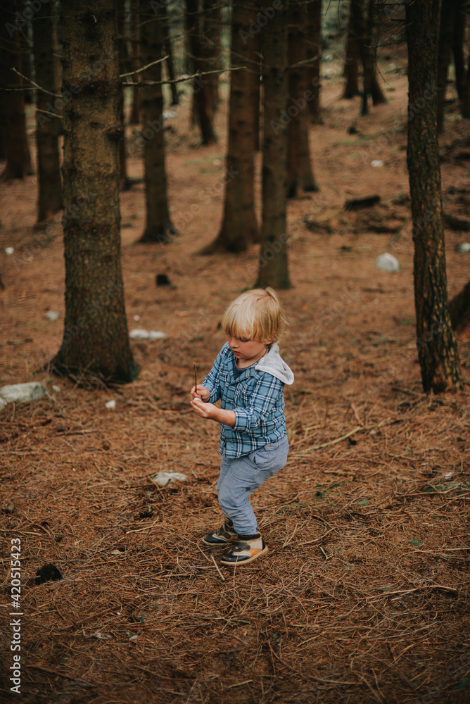 A beautiful blond toddler in a forest A beautiful blond toddler in a forest