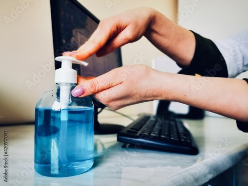 disinfection of hands with a sanitizer after working with a computer