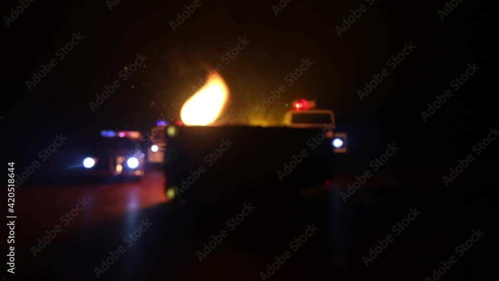 Police car chasing a car at night with fog background. 911 Emergency response police car speeding to scene of crime. Selective focus Police car chasing a car at night with fog background. 911 Emergency response police car speeding to scene of crime. Selective focus