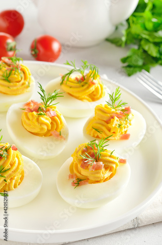 Stuffed eggs with egg yolk, bacon, mustard and dill