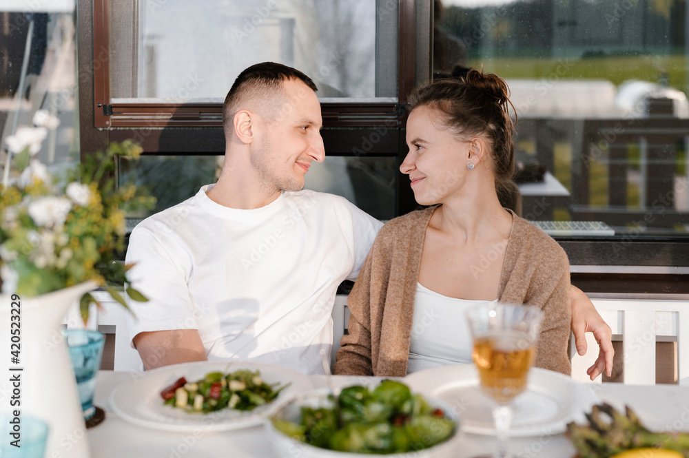 Happy couple hugging during lunch on terrace Happy couple hugging during lunch on terrace