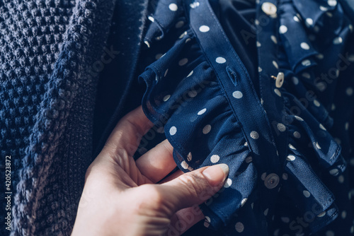 woman looking at frill of dress