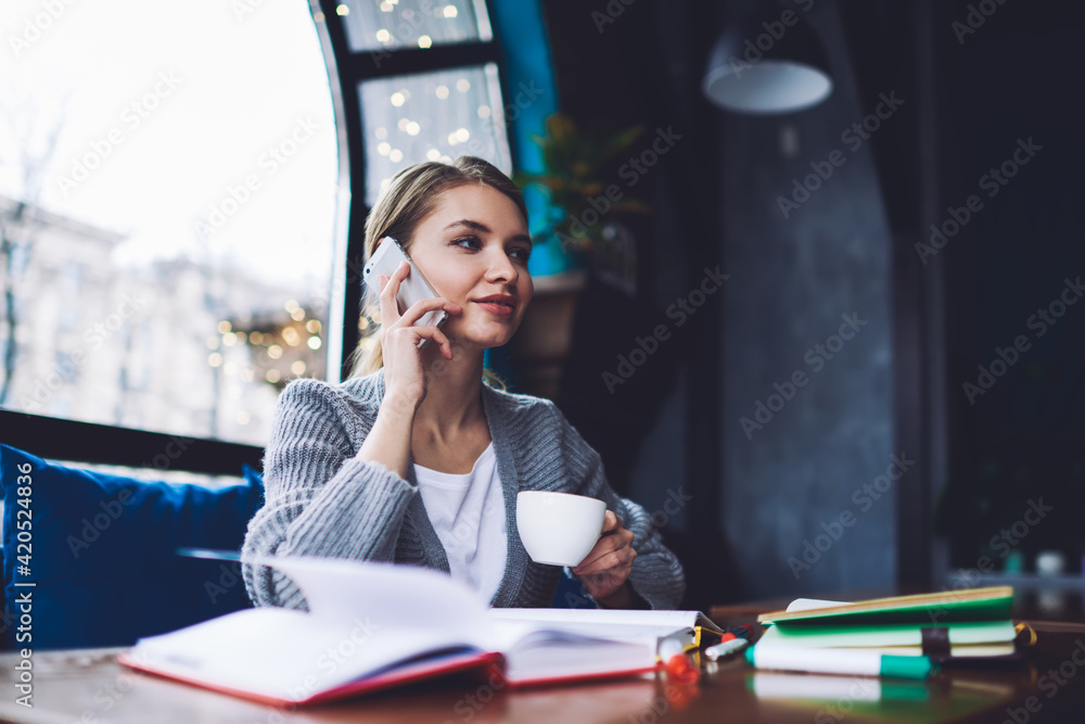 Dreamy woman having conversation on smartphone Dreamy woman having conversation on smartphone