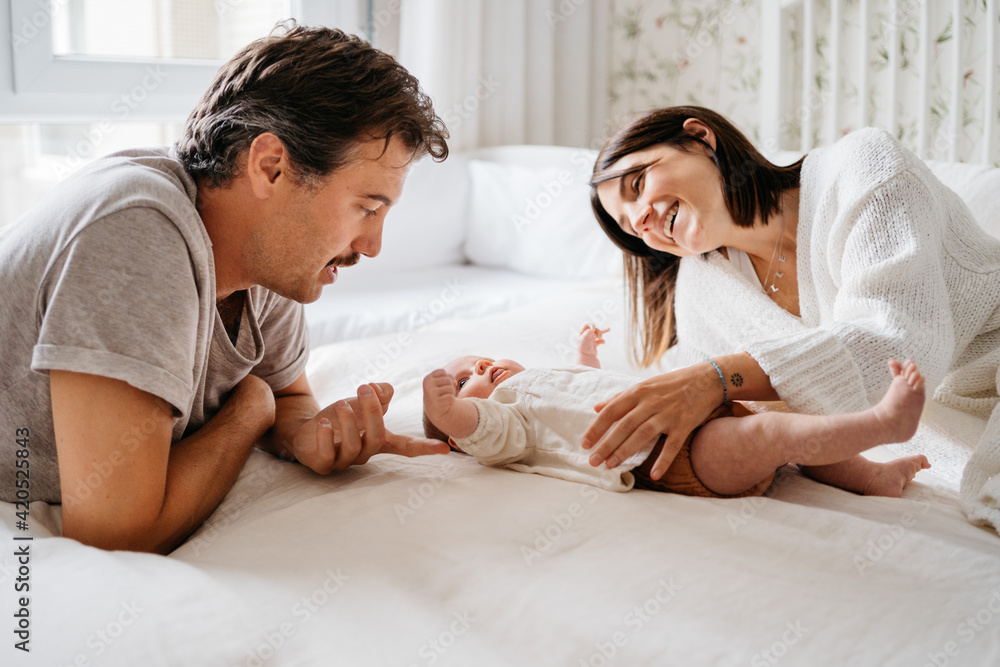 Young parents with baby at bed Young parents with baby at bed