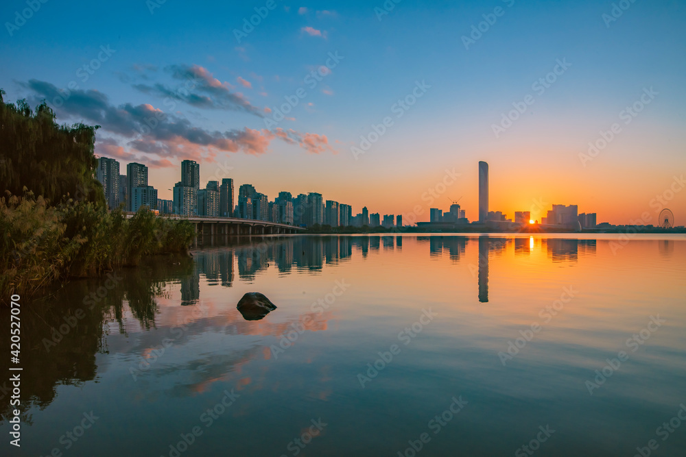 Fototapeta premium sunset over the city or lake