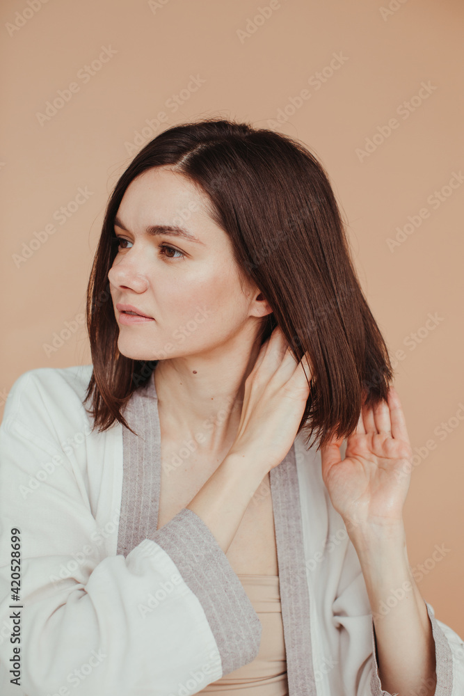 Brunette model apply haircare treatment Brunette model apply haircare treatment