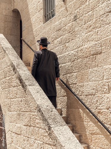 A jewish man climbing stairs in Jerusalem photo