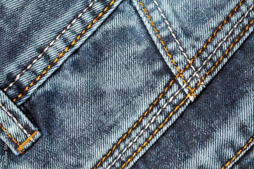Jeans background. Denim fabric with seams close-up. Jeans background. Denim fabric with seams close-up.