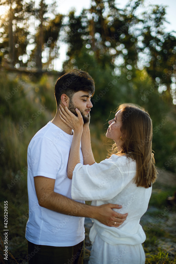 young woman touches the face of a bearded man with her hands and hugs him. romantic relationship. love story young woman touches the face of a bearded man with her hands and hugs him. romantic relationship. love story
