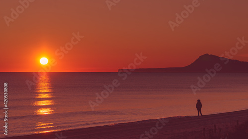 Person silhouette on beach enjoy sunrise