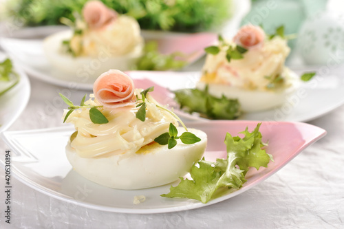 eggs with mayonnaise stuffed with vegetable salad on Easter table photo