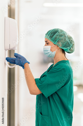 Female Doctor Applying Hand Sanitizer photo