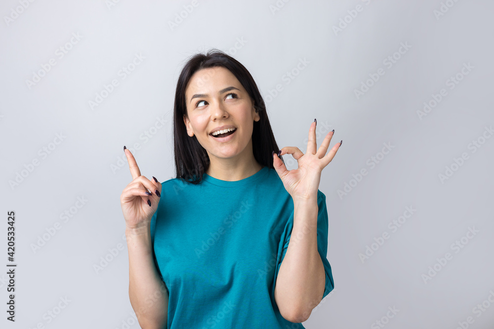Smiling girl gesturing OK sign with her hand