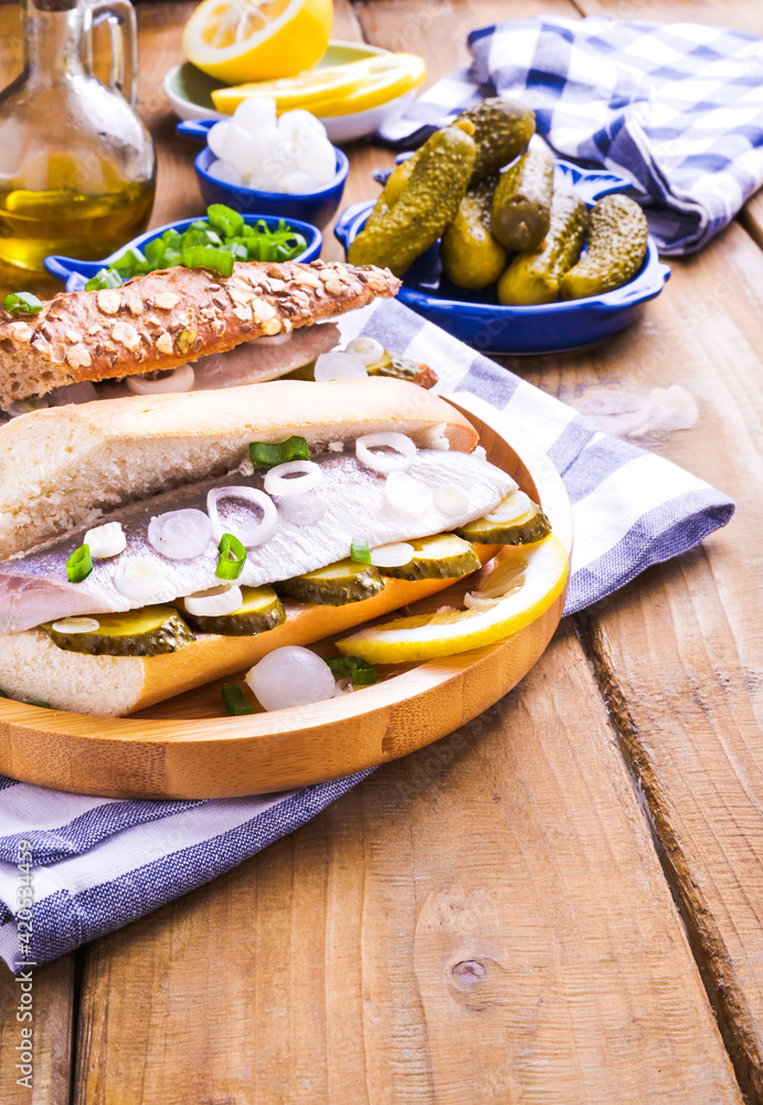 Dutch herring in a sandwich in a white bun. Toast with Dutch herring