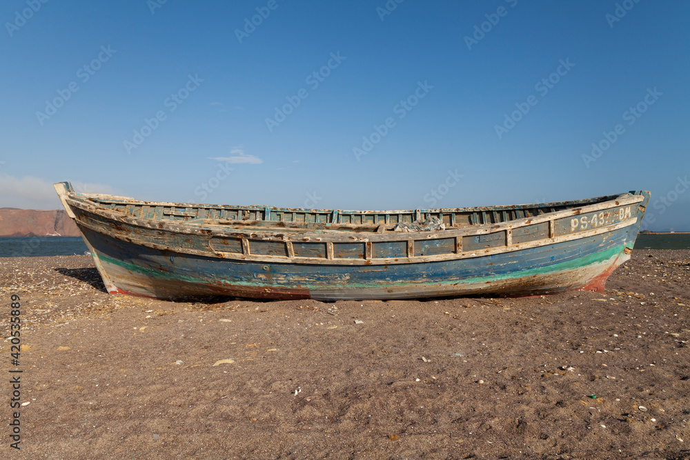 An old fishing barge, washed out by the sea, and totally abandoned, near Playa Roja, on the Lagunillas Route, in the Paracas National Reserve, Pisco, Ica, Peru. An old fishing barge, washed out by the sea, and totally abandoned, near Playa Roja, on the Lagunillas Route, in the Paracas National Reserve, Pisco, Ica, Peru.