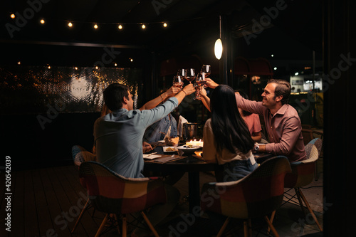 Friends Enjoying Dinner at Restaurant photo