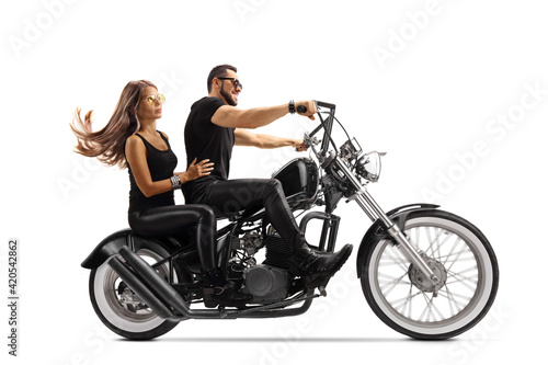 Young man and woman on a chopper motorbike