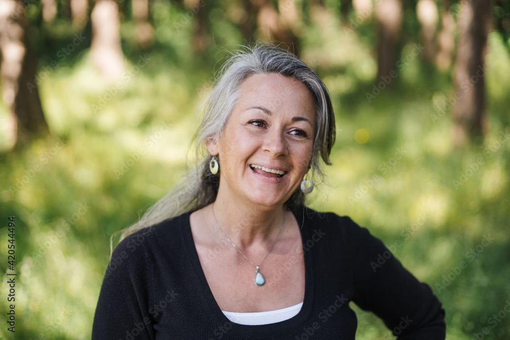 Mature, healthy woman outside enjoying life. Mature, healthy woman outside enjoying life.