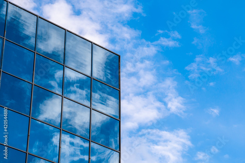 reflection of the sky and clouds on the glass-covered building