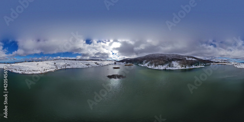 360 degree drone shooting of the Biviere lake in the heart of the Nebrodi mountains in winter. View of Etna and the Aeolian Islands. Sicily in winter. Sicilian mountains.