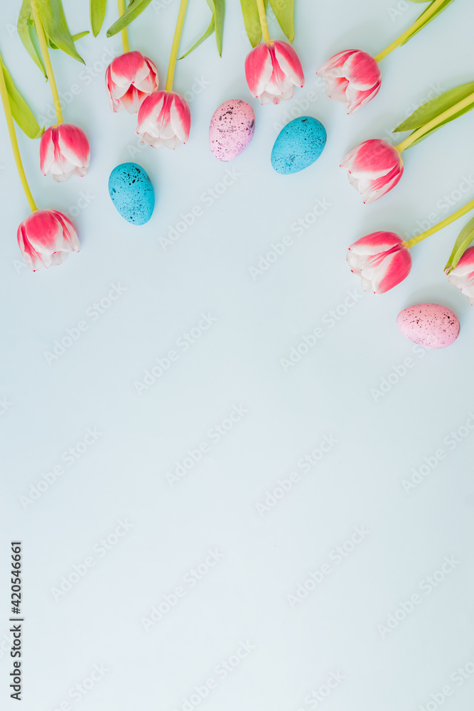 Flat lay easter composition with pink tulips and eggs on color background Flat lay easter composition with pink tulips and eggs on color background