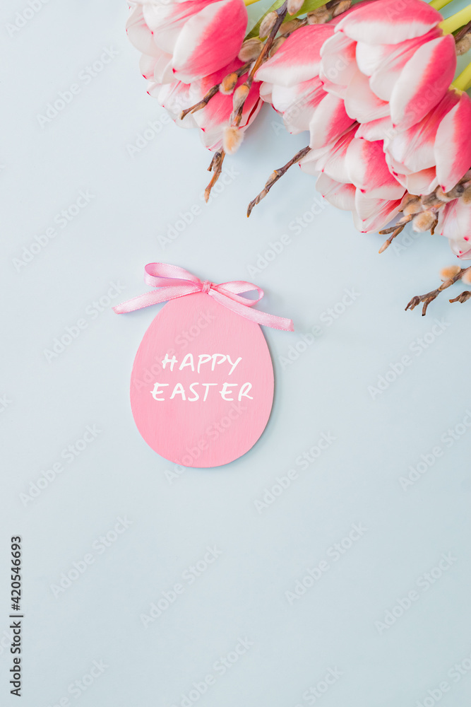 Fototapeta premium Flat lay easter composition with pink tulips and eggs on color background