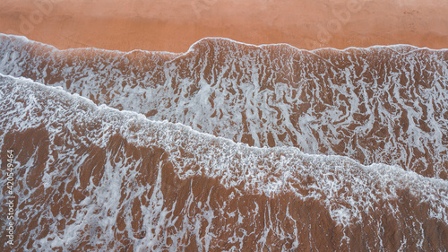 Waves of the ocean running slowly on the coast, calm sea. photo