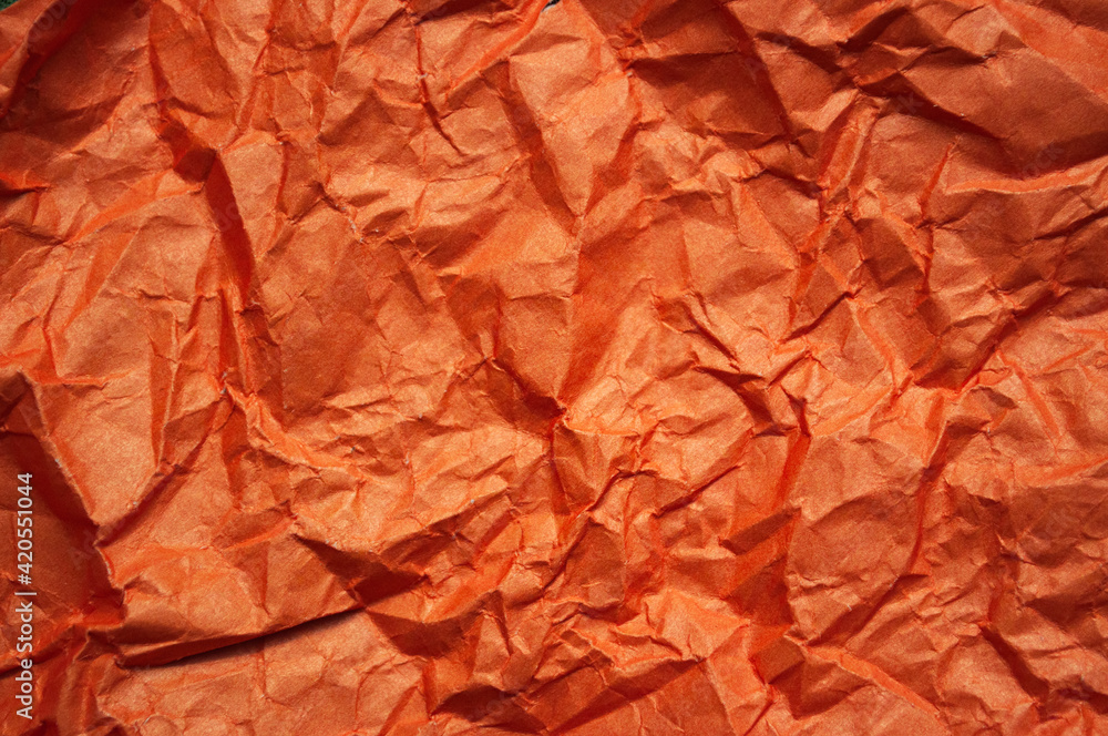 Crumpled orange textured paper background Crumpled orange textured paper background