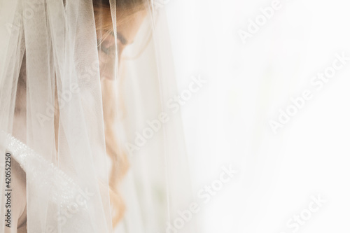 the bride closed her eyes and tulle in the foreground. profile.