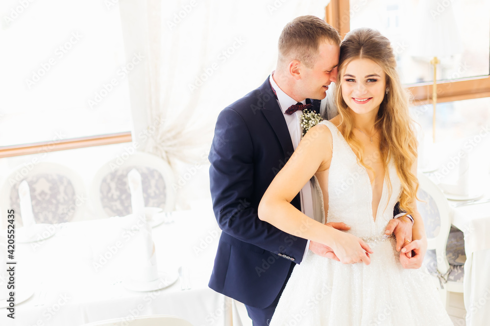 the bride in a beautiful dress looks into the camera and smiles the bride in a beautiful dress looks into the camera and smiles