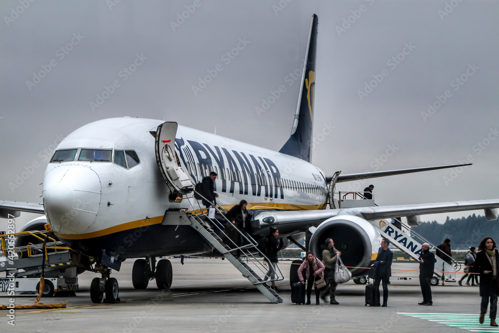 Passengers getting off the plane of Ryanair company at the Porto airport  Stock Photo | Adobe Stock
