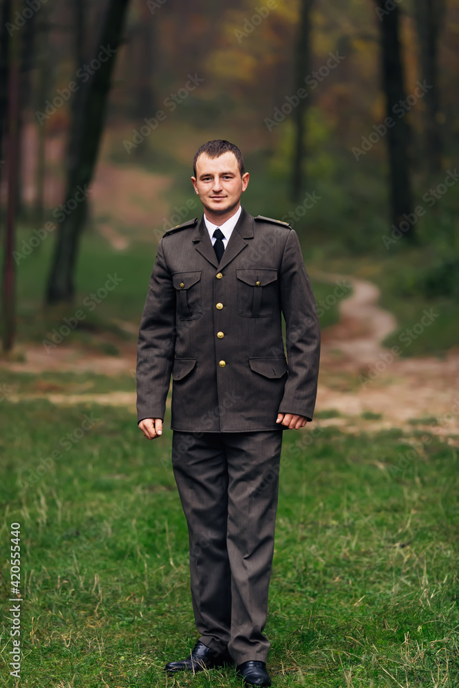 man in military uniform looking at the camera. walking in the pa man in military uniform looking at the camera. walking in the pa
