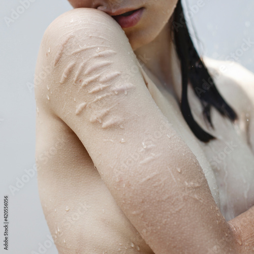 Vulnerable sensual woman standing under water photo