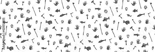 Seamless pattern of prehistoric weapons, handprint, mask and fish vector illustration. Endless illustration of hand drawn grunge primitive human tribal life. Isolated silhouettes on white background