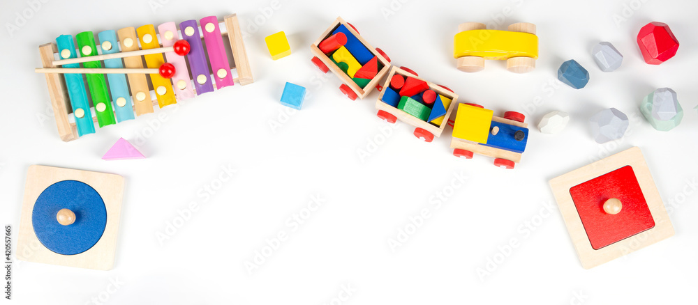Baby kid toy banner. Colorful educational and musical toys on white background. Top view, flat lay