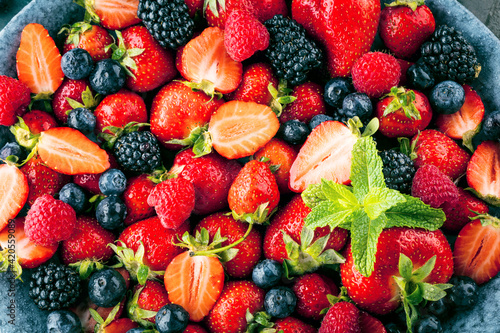 Fototapeta Naklejka Na Ścianę i Meble -  Berries colorful assorted mix of strawberry, blueberry, raspberry, blackberry on dark background