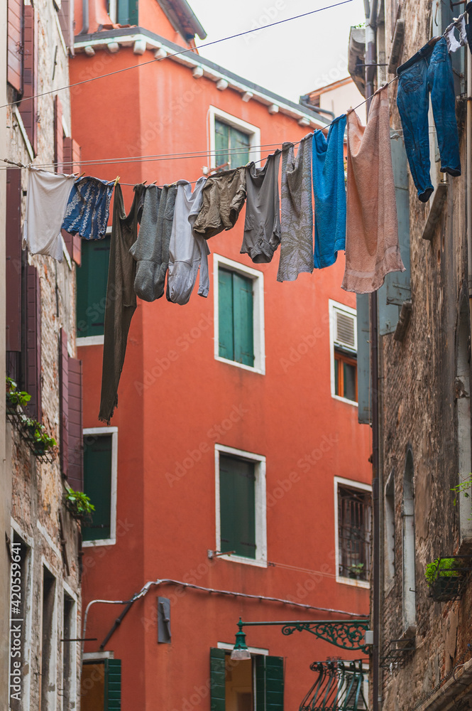 Laundry hanging on the clothesline between buildings Stock Photo