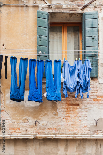 Wallpaper Mural Blue laundry on the clothesline outside the window in Venice Torontodigital.ca