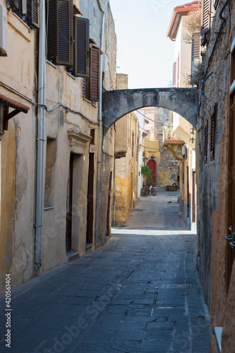 Picturesque Rhodes old town street with an arch and no people. Dodecanese, Greece. © Majopez