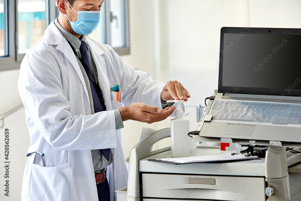 A doctor disinfecting hands