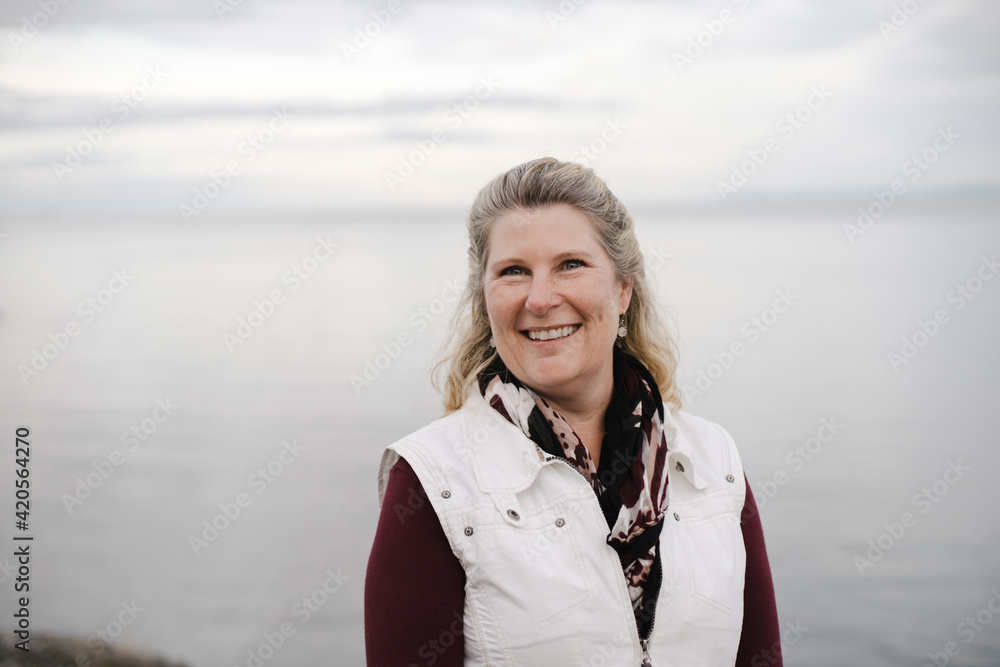 Mature woman portrait outside near ocean. Mature woman portrait outside near ocean.