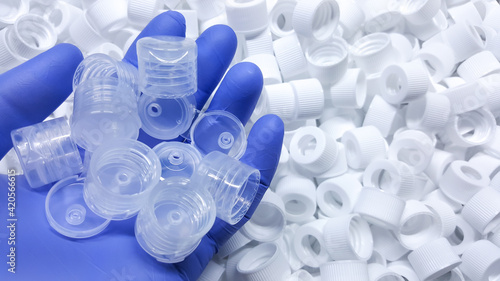 White Medical plastic bottle caps. Made from injection molding machine, of the manufacturing and assembly department, In the plastics industry photo
